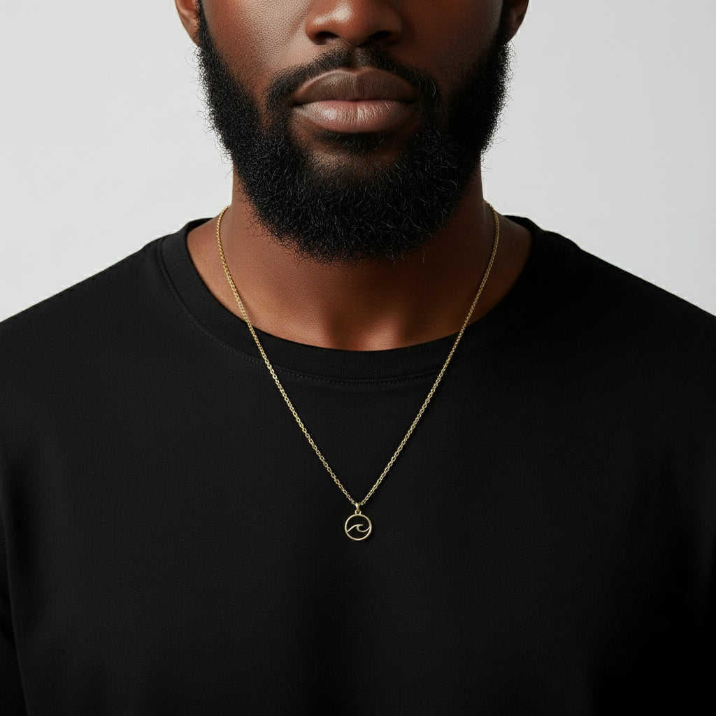 Gold necklace with an ocean wave pendant